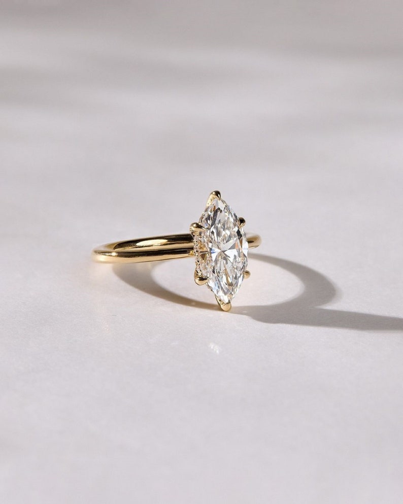2ct marquise cut Lab Grown solitaire engagement ring set in 14K yellow gold