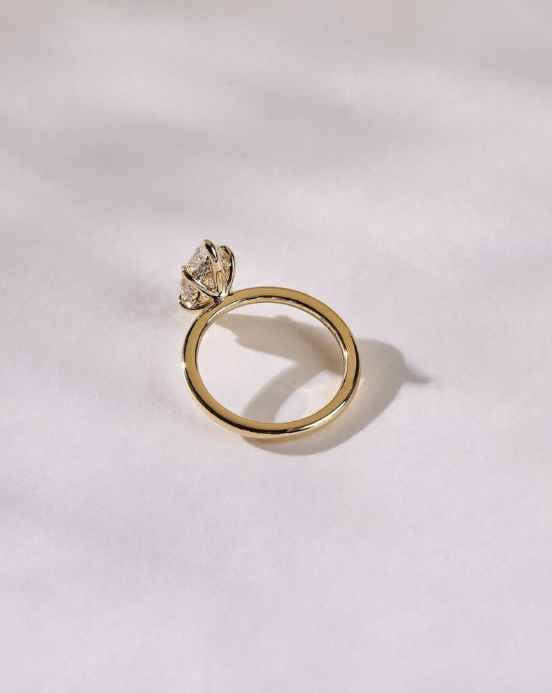 2ct marquise cut Lab Grown solitaire engagement ring set in 14K yellow gold