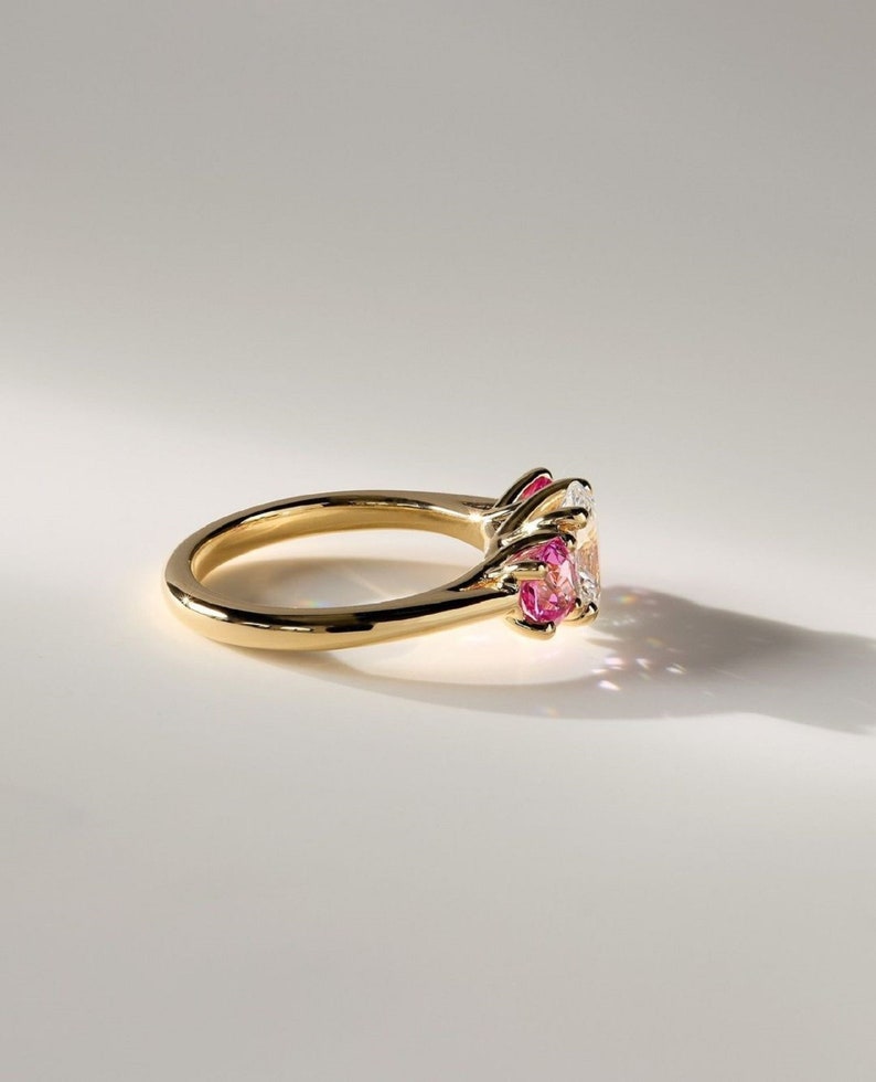 2ct oval Lab-Grow Diamond & Pink Each 0.75ct lab Grow Three-Stone Ring in 14K Yellow Gold