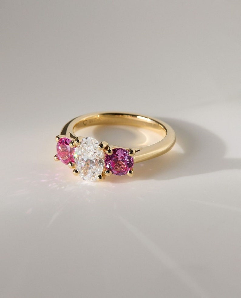 2ct oval Lab-Grow Diamond & Pink Each 0.75ct lab Grow Three-Stone Ring in 14K Yellow Gold