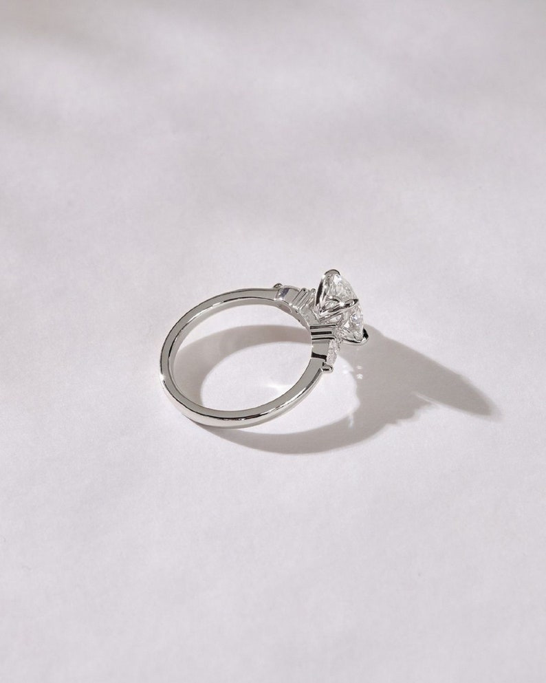3.50ct Oval Cut Lab-Grown Diamond Cluster Engagement Ring in White Gold on Side Pear Shape Each 0.50ct.