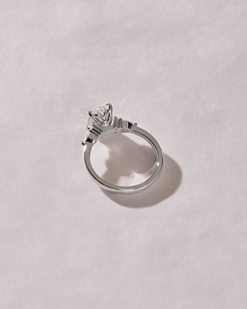 3.50ct Oval Cut Lab-Grown Diamond Cluster Engagement Ring in White Gold on Side Pear Shape Each 0.50ct.
